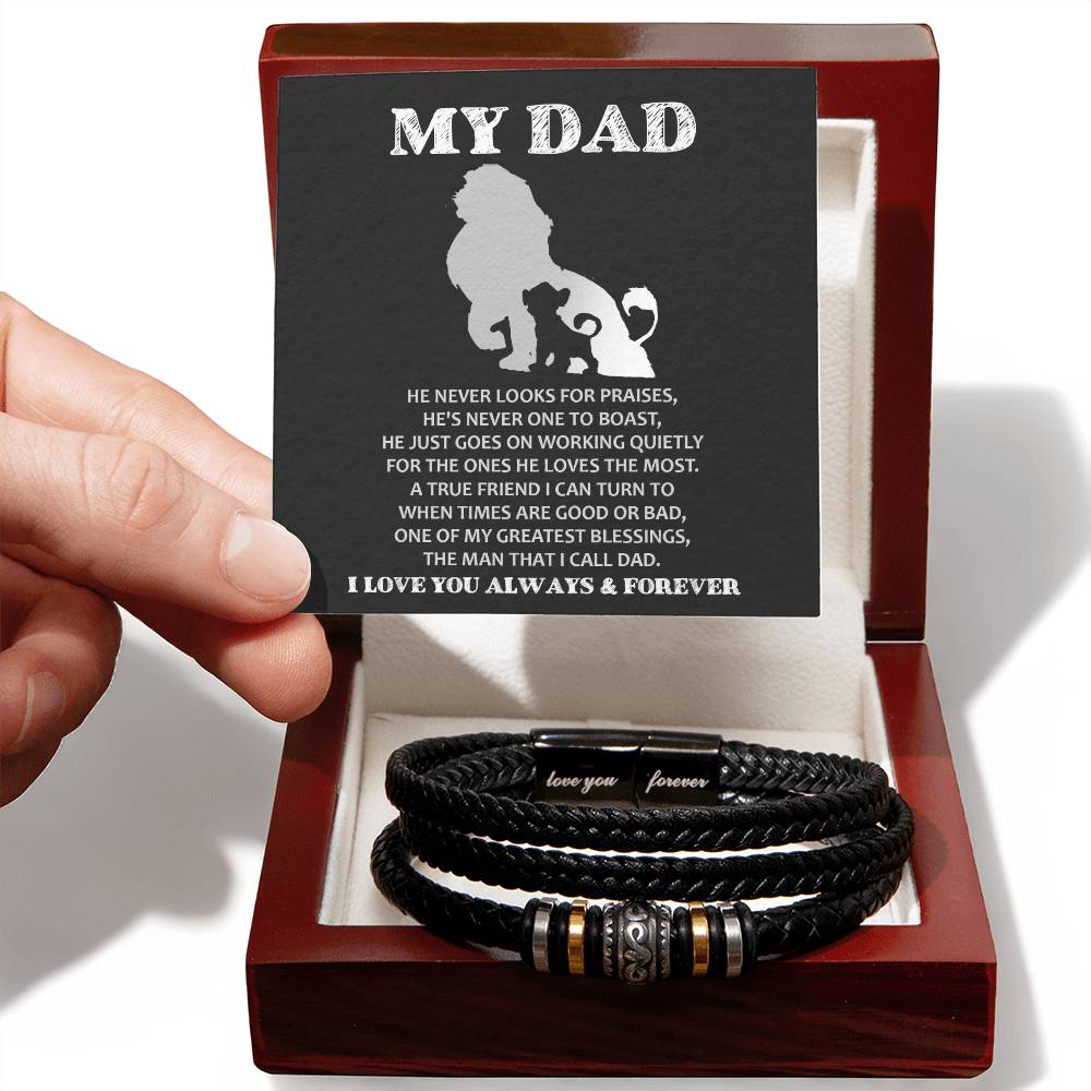 A hand presenting a gift box containing the "To Dad, The Man - Love You Forever" bracelet with a "my dad" poem printed on the box lid.