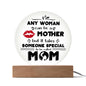 The "To Mom, Someone Special Acrylic Circle Plaque" is a round illuminated sign featuring the heartfelt message "Any woman can be a mother, but it takes someone special to be called mom," crafted from premium acrylic on a wooden base. Perfect for special occasions.