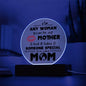 The "To Mom, Someone Special Acrylic Circle Plaque" is a round LED sign with premium acrylic that reads, "Any woman can be a mother but it takes someone special to be called mom," featuring a lip graphic and blue backlight—ideal for special occasions.