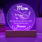 A round, translucent To Mom, Hold My Hand - Acrylic Circle Plaque with subtle etchings, mounted on a rectangular wooden LED base, isolated on a white background.