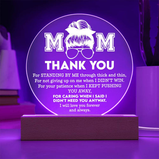 A glowing purple circular LED lamp with the inscription "mom thank you" and a heartfelt message of appreciation, displayed on the To Mom, Standing By Me - Acrylic Circle Plaque set on a wooden base.