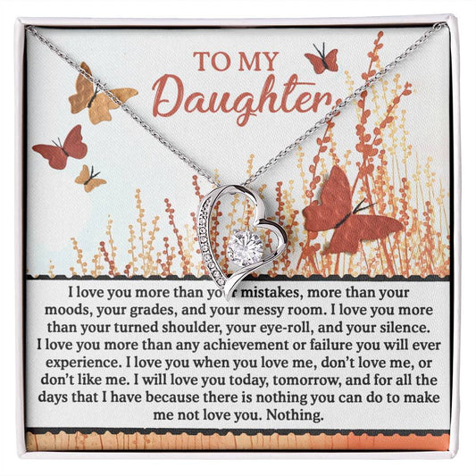 The Daughter-Love You More - Forever Love Necklace, embellished with CZ crystals and a gold finish, features a heart-shaped pendant. Its graceful design includes delicate butterflies and conveys a heartfelt message of unconditional love for your daughter.