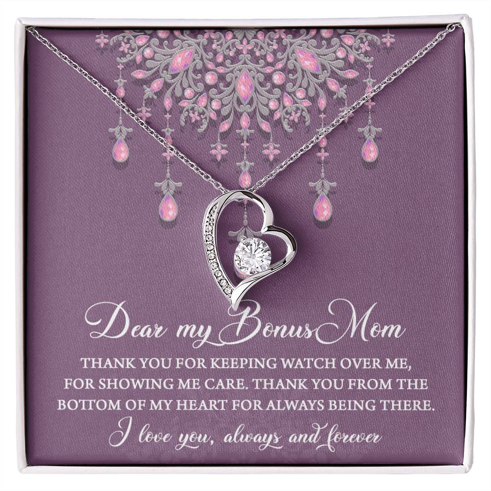 A "To Bonus Mom, Always Being There - Forever Love Necklace" with a heart pendant and pink gemstones displayed in a box with a heartfelt message, perfect as a gift for mom.