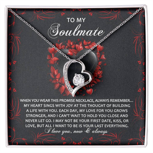The Soulmate-Hold You Close - Forever Love Necklace features a heart-shaped pendant with a CZ crystal, set on a "To My Soulmate" card accented by red florals. Its gold finish embodies romance and eternal connection.