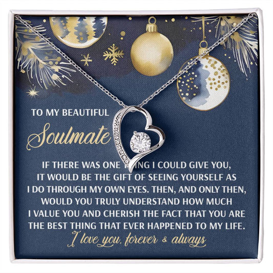 The Soulmate-One Thing - Forever Love Necklace, featuring a heart-shaped design with a CZ crystal, gracefully rests on a card embellished with gold and silver ornament designs. This card conveys a heartfelt message of appreciation for a soulmate, perfectly accentuated by the necklace's striking gold finish.