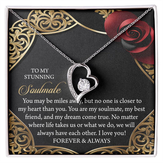 The Soulmate-Have Each Other Forever Love Necklace, shaped like a heart and embellished with a CZ crystal in white gold finish, is set on a decorative card with an elegant floral design and romantic message.