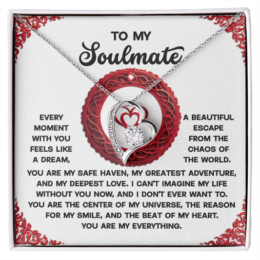 The Soulmate-Like A Dream - Forever Love Necklace showcases intertwined hearts with a sparkling cubic zirconia, elegantly displayed on a card with a heartfelt message. With its gold finish, this exquisite piece symbolizes an eternal bond.