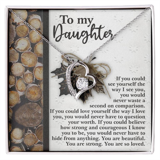 The "Daughter-Holds For You 2 - Forever Love Necklace," featuring a CZ crystal pendant in a heart shape and elegantly crafted with a white gold finish, is showcased against a backdrop bearing a heartfelt message to a daughter.