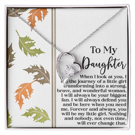The Daughter-Biggest Fan - Forever Love Necklace, adorned with a heart-shaped design and CZ crystal, is gracefully showcased on a greeting card decorated with autumn leaves, conveying a message of lasting love.