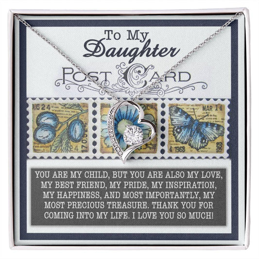 The Daughter-Precious Treasure - Forever Love Necklace showcases a silver heart with an intricate floral design, embellished with a radiant CZ crystal. It is elegantly presented on a card adorned with butterfly and flower postage stamps, delivering a heartfelt message for your daughter. This piece is available in a stunning white gold finish for timeless elegance.