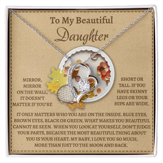 The Daughter-On The Wall - Forever Love Necklace showcases a heart-shaped pendant with a gold finish, elegantly complemented by a card containing a heartfelt message about inner beauty and love meant for a daughter.