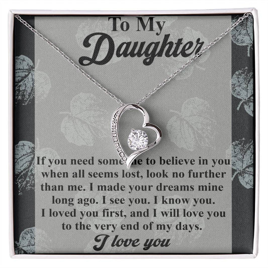 The Daughter-My Days - Forever Love Necklace features a heart-shaped pendant with a brilliant CZ crystal, beautifully crafted with a white gold finish. It is presented on a card bearing heartfelt messages of love and support for a daughter.