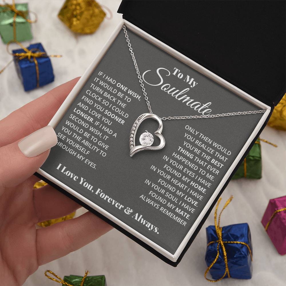 A hand holding a jewelry box with a ShineOn Fulfillment Forever Love Necklace featuring a gold heart pendant and a sentimental message for a soulmate.