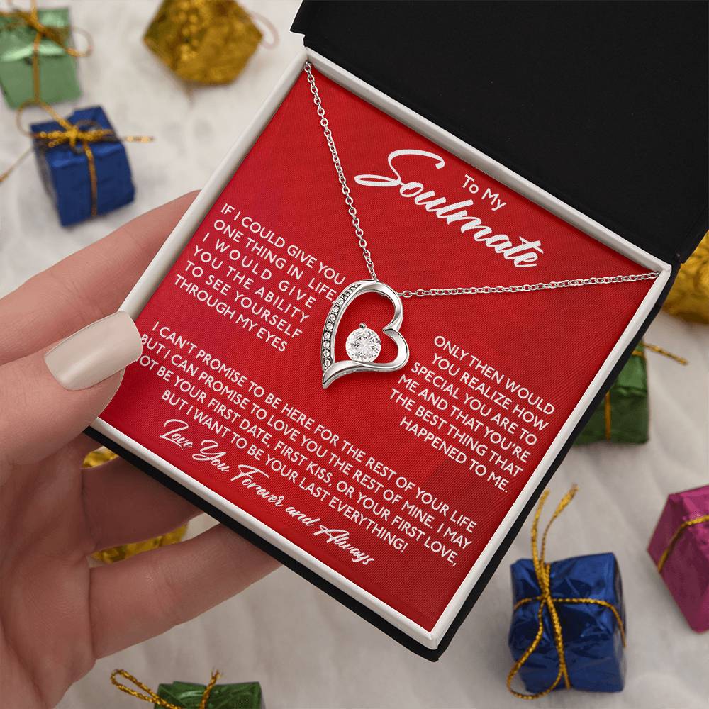 A hand holding an open gift box containing a "To My Soulmate, You Are Special To Me - Forever Love" necklace from ShineOn Fulfillment in the shape of a heart and a message for a soulmate, with small gift boxes in the background.
