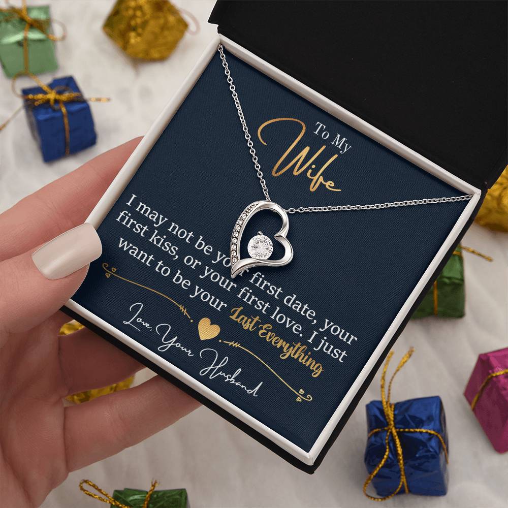 A hand holding a jewelry gift box with a gold finish, ShineOn Fulfillment's To My Wife, I Want To Be Your Everything - Forever Love Necklace and a printed romantic message to a wife from a husband.