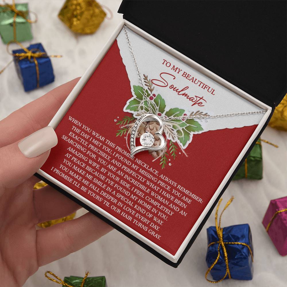 The Soulmate-At Peace - Forever Love Necklace, featuring a heart and diamond pendant, shimmers in an open box and highlights its elegant gold finish next to a card labeled "To My Beautiful Soulmate.