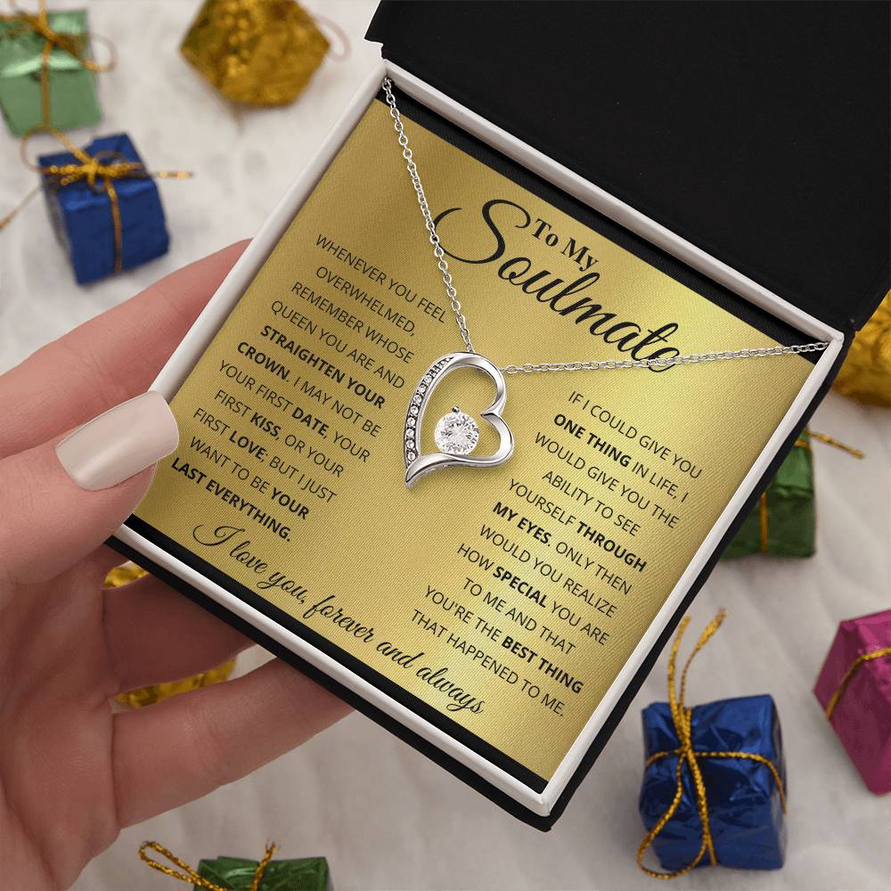 A gold finish pendant necklace with a heart design and an inscription presented in a gift box surrounded by wrapped presents, known as the To My Soulmate, You_re The BEst Thing That Happened To Me - Forever Love Necklace from ShineOn Fulfillment.