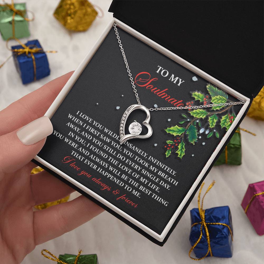 Introducing the Soulmate-You Still Do - Forever Love Necklace, a heart-shaped pendant in a gift box adorned with a sentimental message and holly decoration. This personalized gift comes beautifully wrapped, with charming boxes visible in the background.