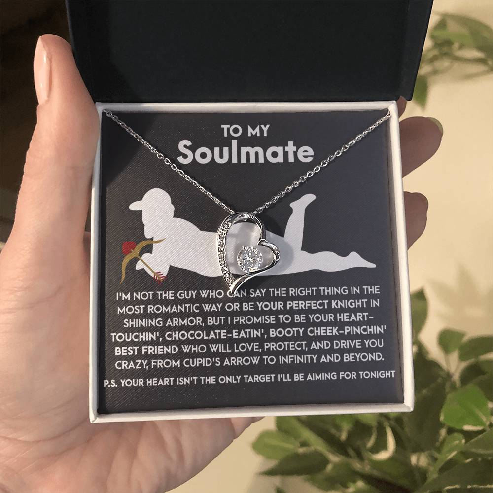 A hand gently cradles a box with the Soulmate-Cupid's Arrow - Forever Love Necklace, featuring a heart-shaped pendant in shimmering white gold, adorned with CZ crystals. Inside rests this delicate piece alongside a heartfelt message for your soulmate.
