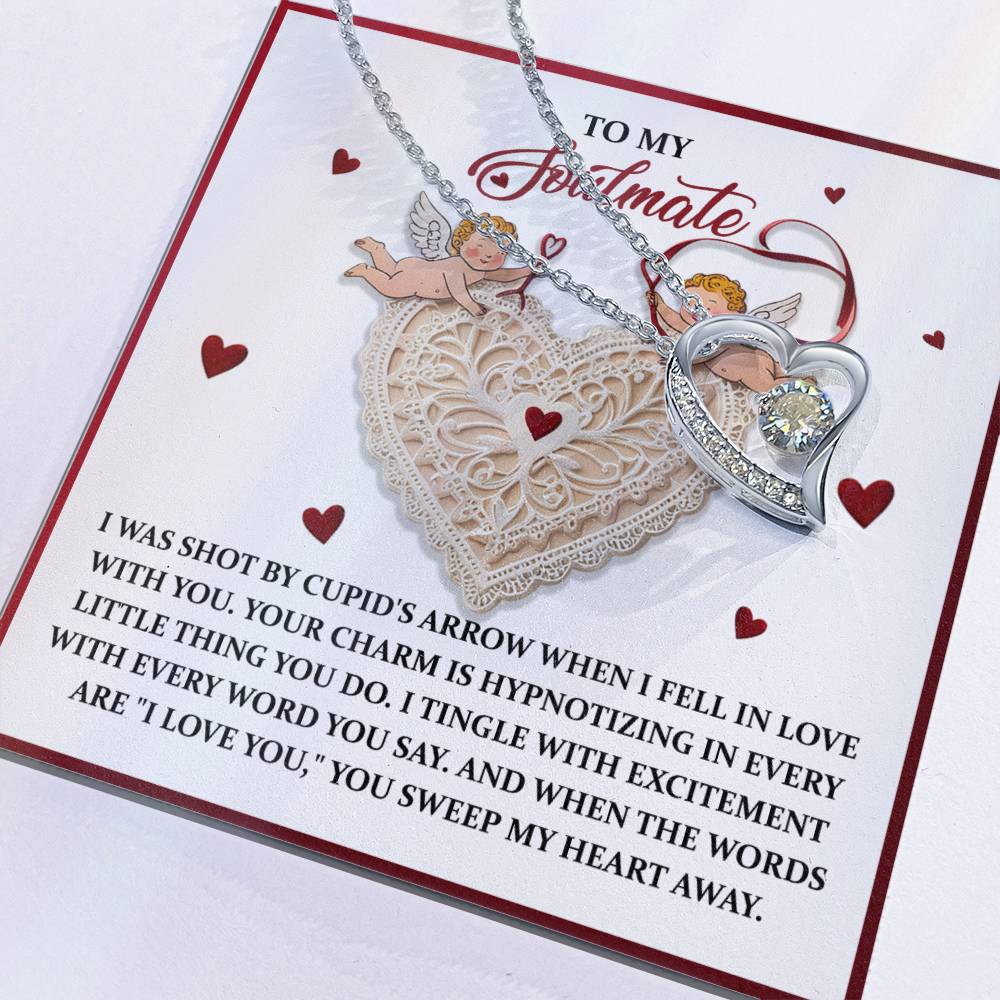The Soulmate-Sweep My Heart - Forever Love Necklace has a heart pendant with a sparkling CZ crystal, presented on a card with romantic text and cupid illustrations. Its gold finish offers timeless elegance, making it an ideal gift for any special occasion.