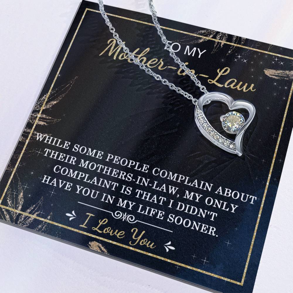 The "To Mother-In-Law, In My Life - Forever Love Necklace" has a heart shape and includes a cubic zirconia stone, presented on a card that reads "To my Mother-in-law," featuring a heartfelt message of appreciation and love.