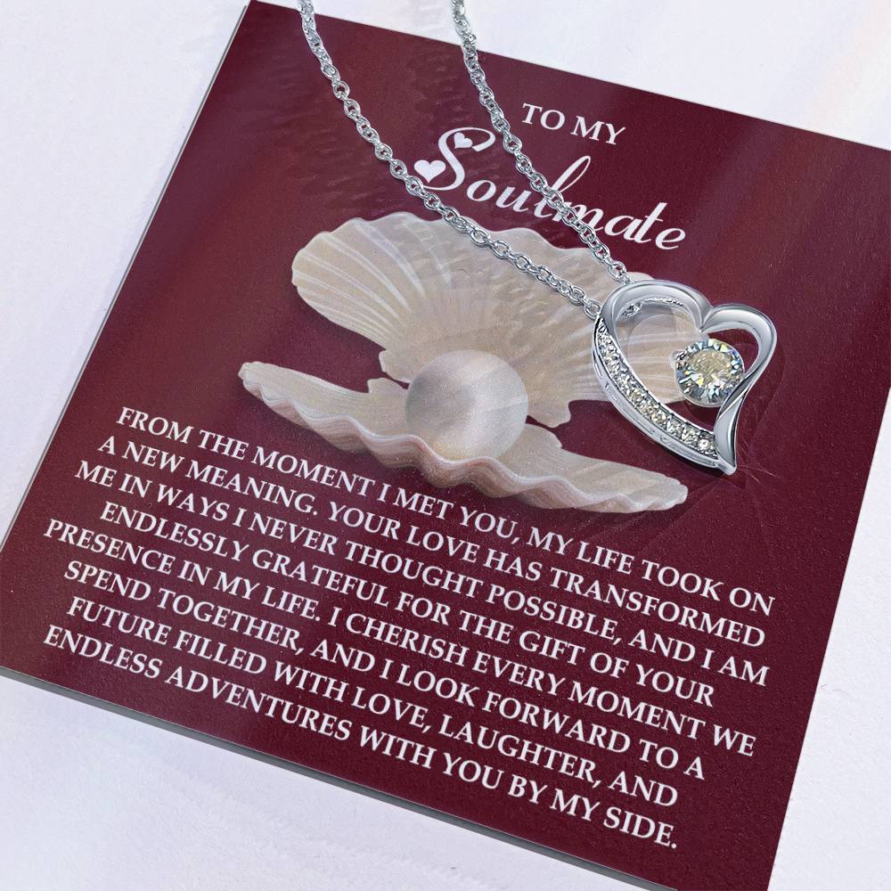 The Soulmate-Every Moment - Forever Love Necklace features a heart-shaped pendant with a cubic zirconia gemstone on a white gold finish chain, elegantly presented on a "To My Soulmate" card with a loving message. It embodies eternal love and gratitude for shared adventures.