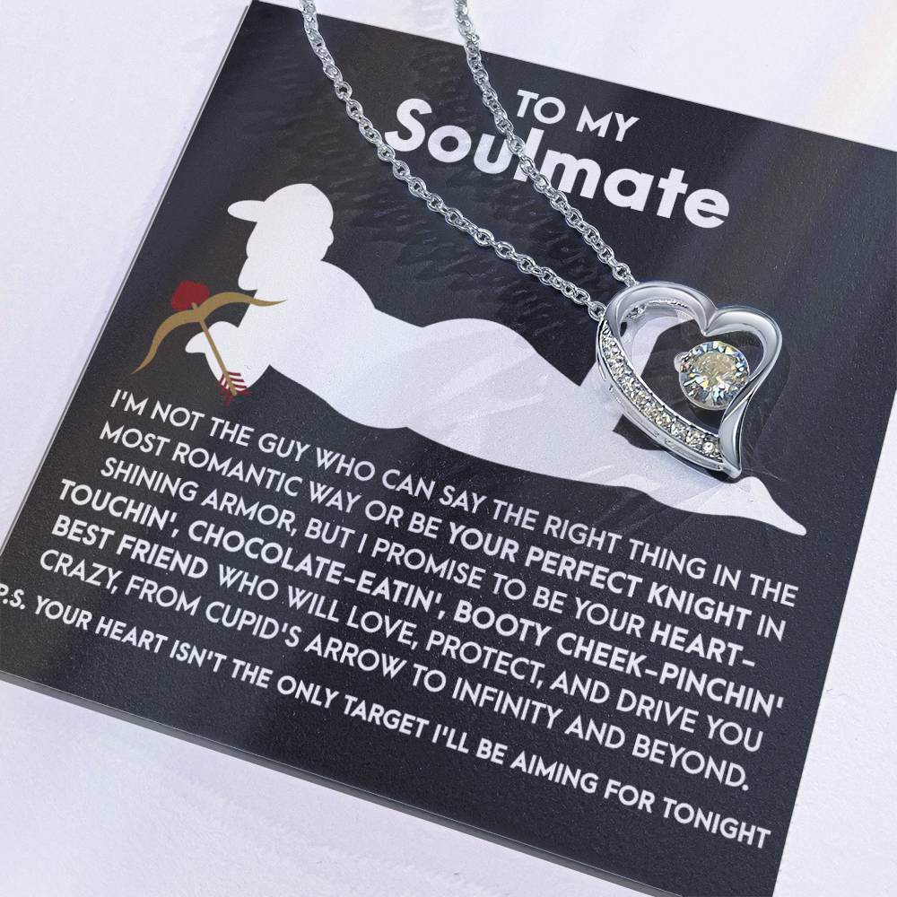 The Soulmate-Cupid's Arrow - Forever Love Necklace features a heart-shaped pendant with a dazzling CZ crystal on a white gold finish chain, elegantly presented on a card titled "To My Soulmate," complemented by a romantic message in white text against a black background.