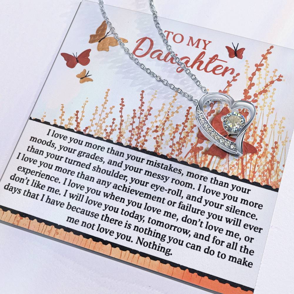 The Daughter-Love You More - Forever Love Necklace, featuring a sparkling cubic zirconia stone, rests on a card with a heartfelt message to a daughter.