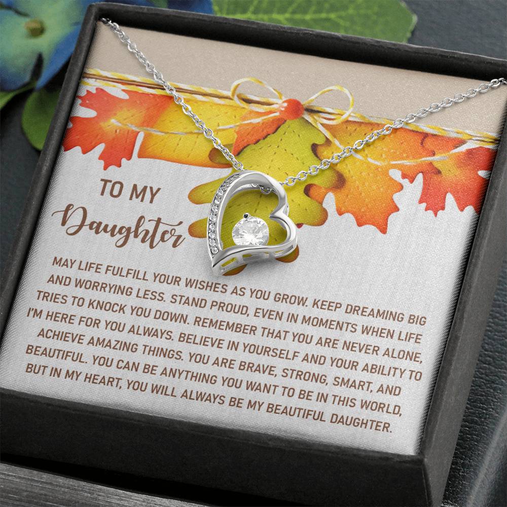 The Daughter-For You Always - Forever Love Necklace, adorned with a heart-shaped pendant featuring a shimmering CZ crystal, is elegantly presented in a box. Its gold finish and heartfelt message make it the perfect gift for a daughter.