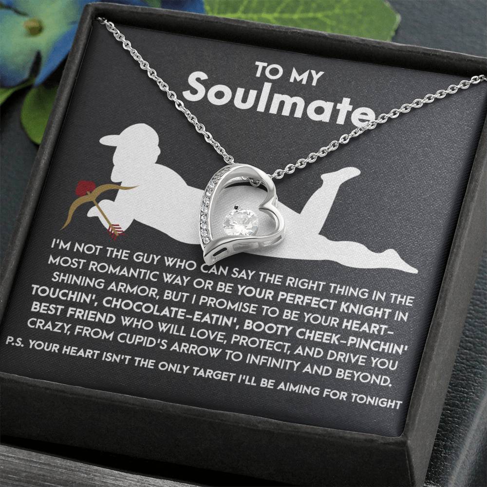 The Soulmate-Cupid's Arrow - Forever Love Necklace features a silver heart-shaped pendant with a sparkling CZ crystal, elegantly presented on a card with a silhouetted figure and romantic text addressing your soulmate. Its white gold finish adds timeless elegance.
