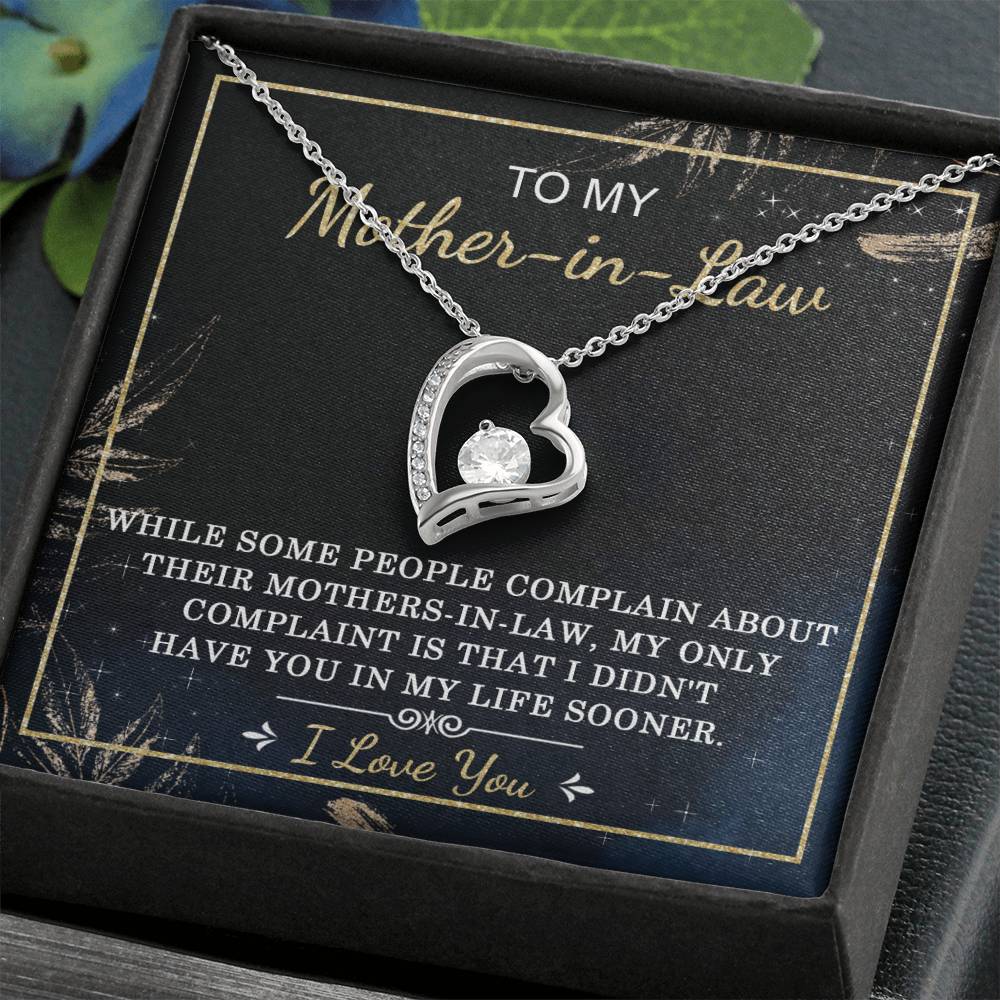 The "To Mother-In-Law, In My Life - Forever Love Necklace," featuring a gold finish and a central cubic zirconia stone, is elegantly presented in a box with a heartfelt message expressing appreciation and love for the mother-in-law.
