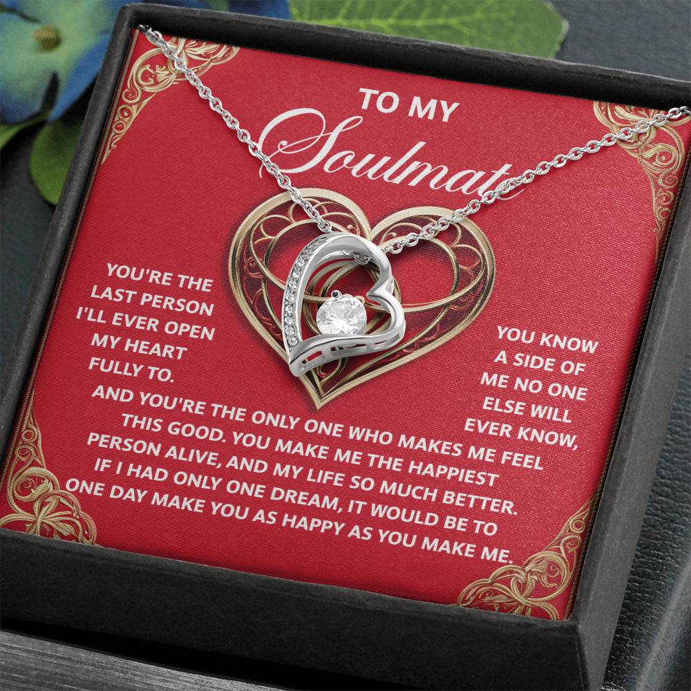 The "Soulmate-The Only One - Forever Love Necklace" features a heart-shaped pendant with intricate design and ornate lettering on a rich red background. Packaged in a box, this CZ crystal necklace makes the perfect romantic gift for your soulmate.
