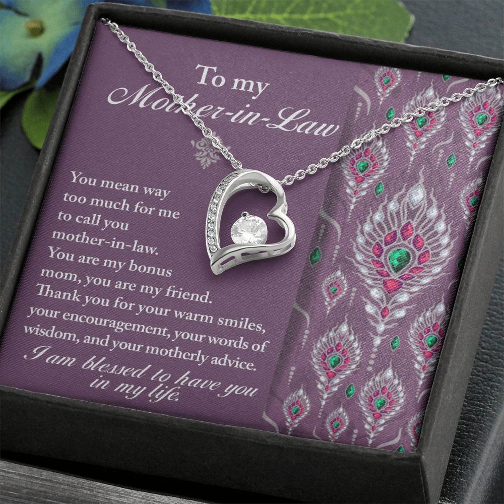 A heart-shaped To Mother-In-Law, Words Of Wisdom - Forever Love Necklace featuring a central gemstone is presented on a decorative card inscribed with "To my Mother-in-Law," paired with a heartfelt message and floral design.