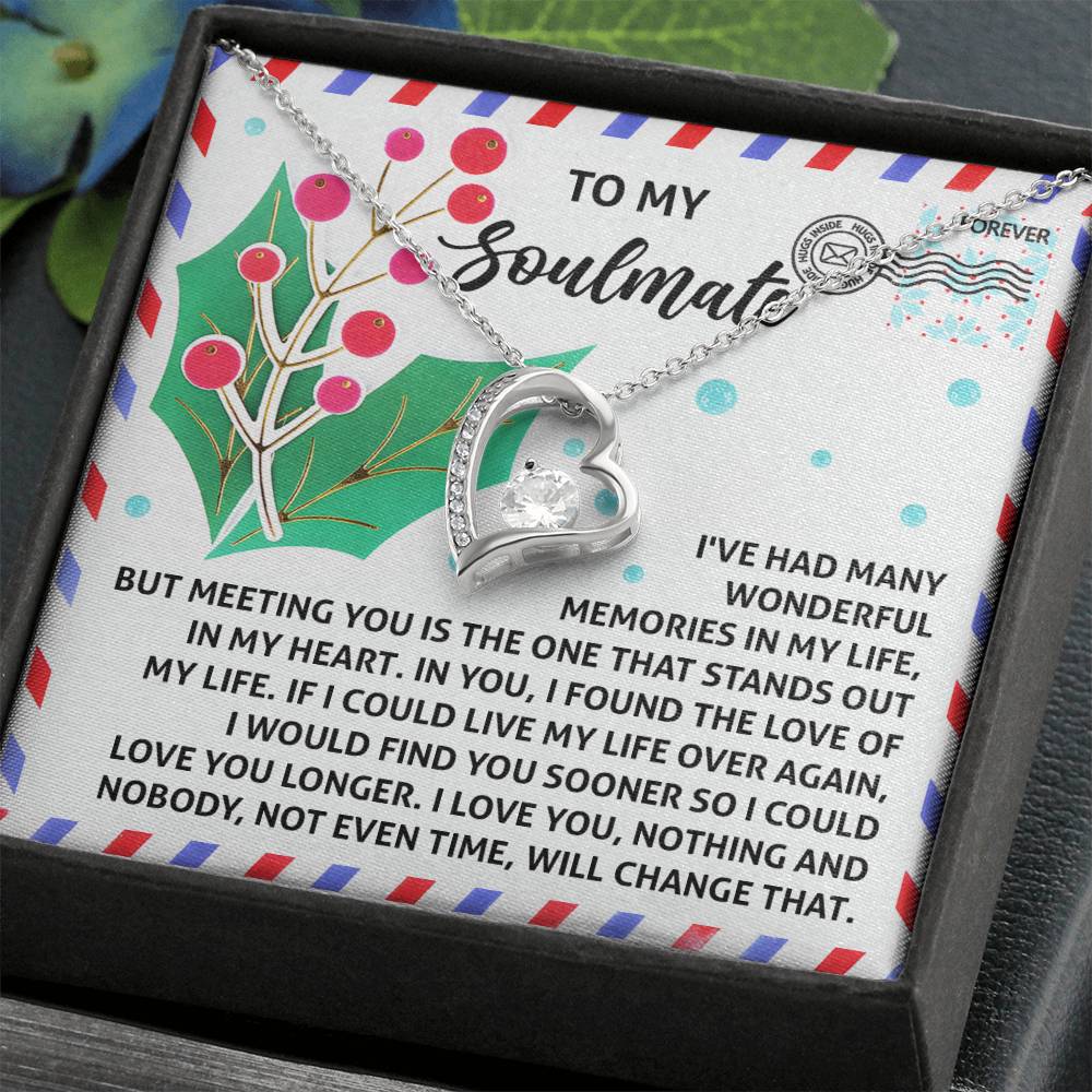 The Soulmate-Love You Longer - Forever Love Necklace, featuring a heart-shaped charm and a dazzling diamond-like cubic zirconia crystal, is elegantly displayed on a card decorated with holly illustrations. Titled "To My Soulmate," it perfectly captures the sentimental message.