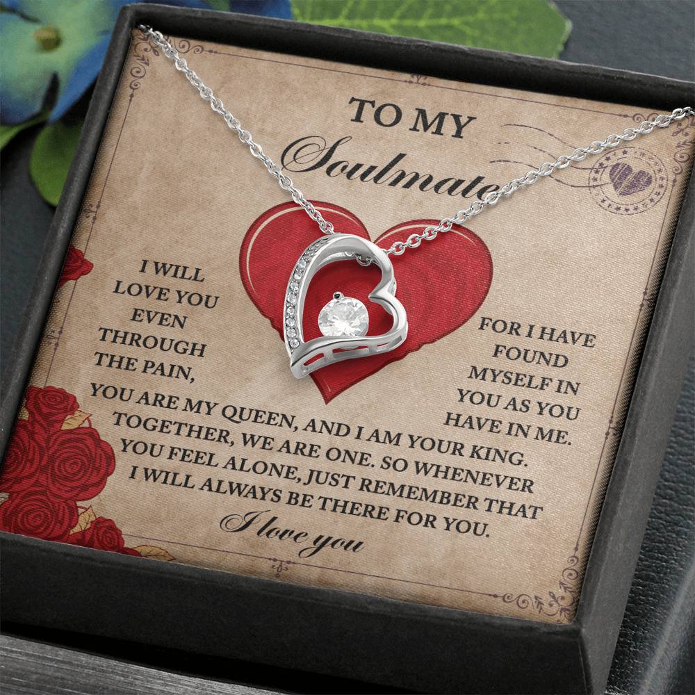 The Soulmate-Found Myself - Forever Love Necklace features a silver heart with cubic zirconia on a card with a loving message, surrounded by red hearts and roses. It’s beautifully presented in a box, highlighted by a green leaf backdrop.