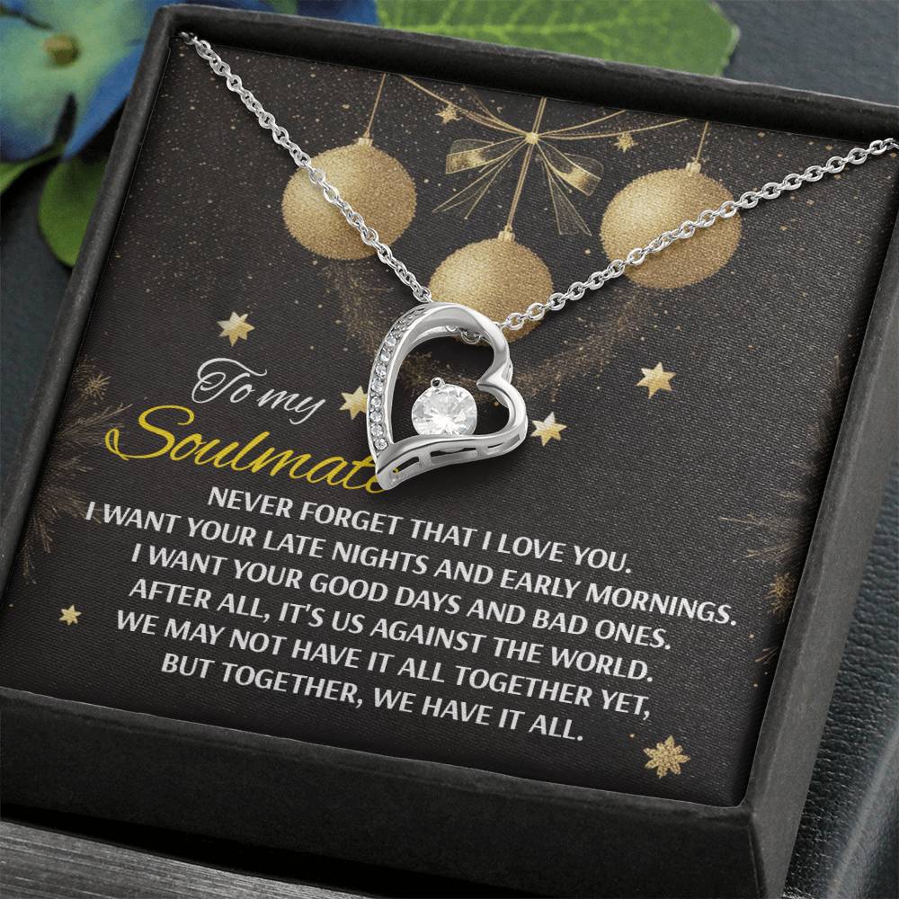 The Soulmate-Have It All - Forever Love Necklace showcases a heart-shaped pendant adorned with a dazzling CZ crystal at its center, gracefully hanging on a chain with a white gold finish. It is beautifully presented on a card featuring a touching message about soulmates and unity.