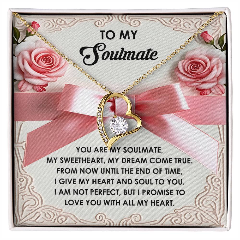The Soulmate-Heart And Soul - Forever Love Necklace is heart-shaped with a central CZ crystal gem, elegantly displayed on a card featuring a loving message to a soulmate, accented by pink roses and a large pink bow.