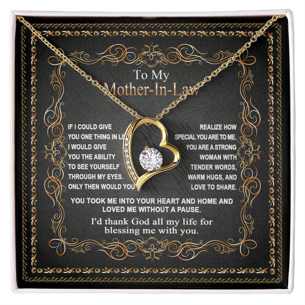 A heart-shaped "To Mother-In-Law, Through My Eyes - Forever Love Necklace" with a diamond is placed on a decorative card, expressing gratitude to your mother-in-law for her love and support. This beautiful gift for your mom-in-law conveys heartfelt appreciation.