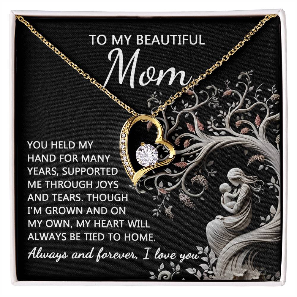The "To Mom, On My Own - Forever Love Necklace" boasts a heart-shaped pendant inscribed with the heartfelt message to "Mom" and comes elegantly presented in a black gift box. Accentuated by a sparkling Cubic Zirconia stone, this necklace beautifully conveys gratitude and love, celebrating the enduring support and bond between mother and child.