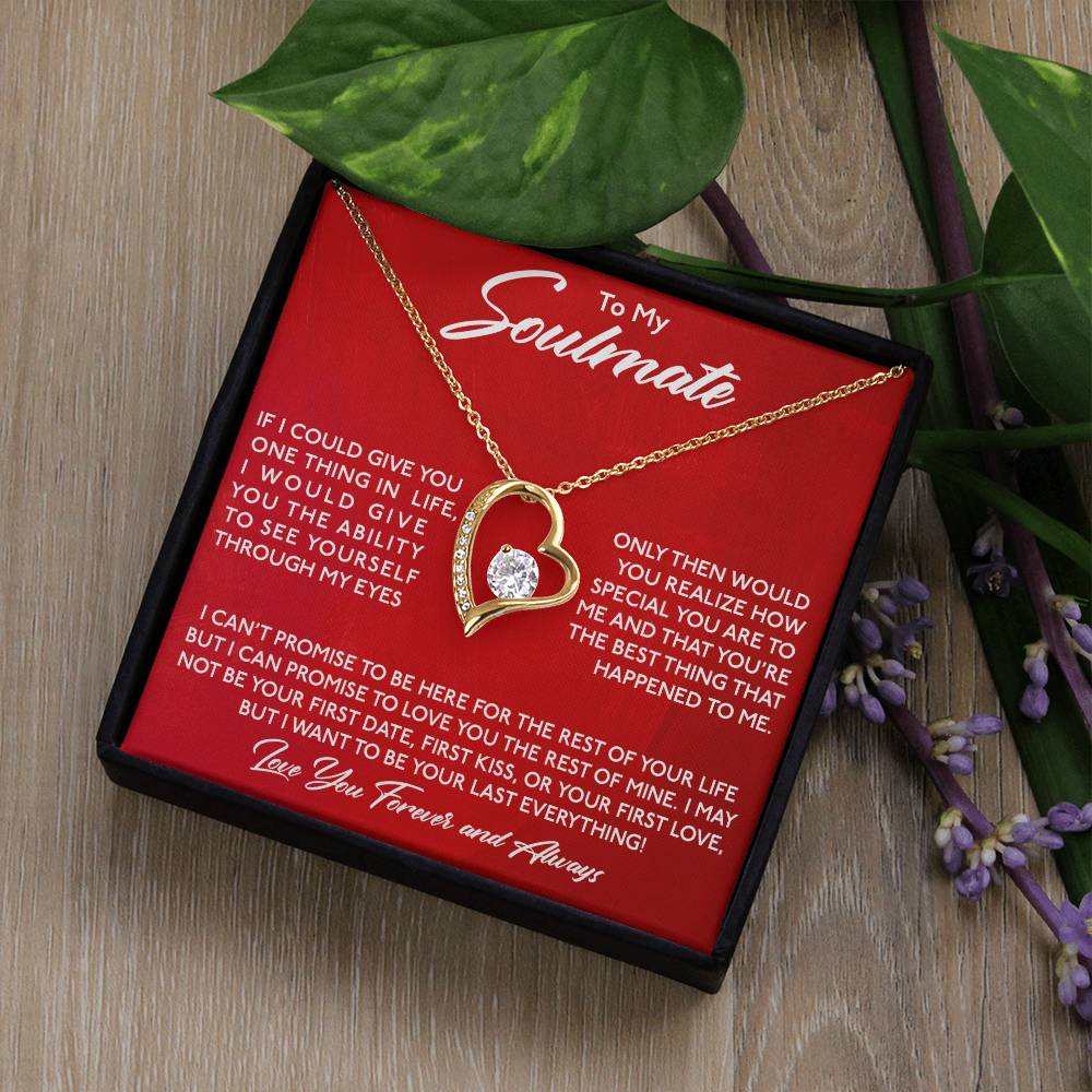 A To My Soulmate, You Are Special To Me - Forever Love Necklace by ShineOn Fulfillment, a heart-shaped gold finish necklace with an engraved love message presented in a red box, accompanied by purple flowers on a wooden surface.