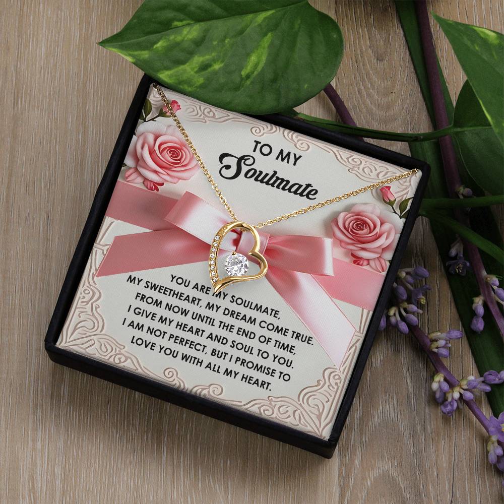 The Soulmate-Heart and Soul - Forever Love Necklace includes a gold heart-shaped pendant with a CZ crystal, elegantly presented in a gift box adorned with floral accents and a romantic message.