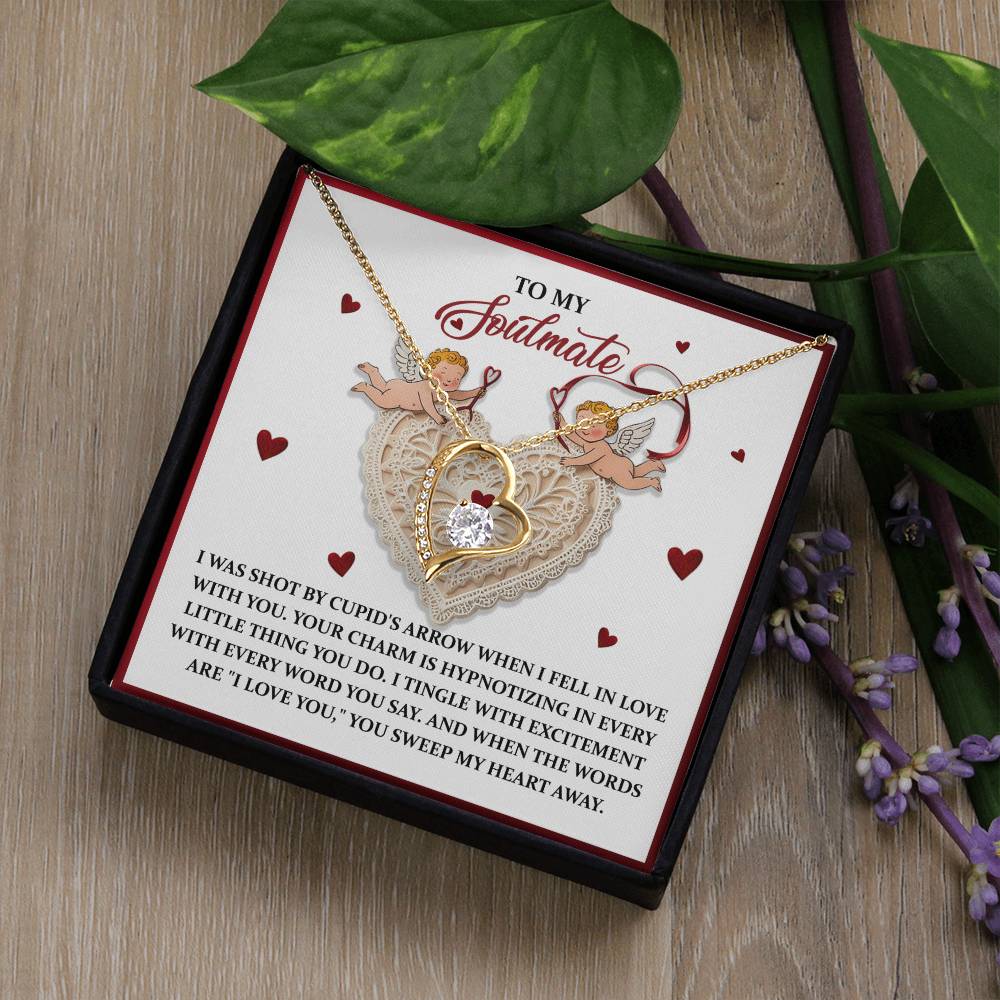The Soulmate-Sweep My Heart - Forever Love Necklace, with a heart design and central CZ crystal, comes in a "To My Soulmate" box featuring floral accents and cherubs, all highlighted by a luxurious gold finish.