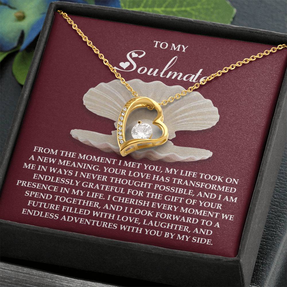 The Soulmate-Every Moment - Forever Love Necklace is a stunning gold heart-shaped design with a cubic zirconia gemstone. It comes with a message card expressing love and gratitude for your soulmate, available in an elegant white gold finish.