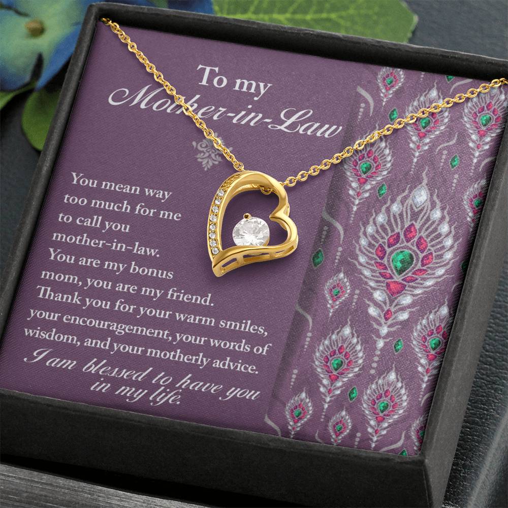 The "To Mother-In-Law, Words Of Wisdom - Forever Love Necklace" features a gold heart-shaped pendant with a central gem, elegantly displayed in a box. The lid showcases a purple background adorned with a heartfelt message expressing gratitude and appreciation for a mother-in-law. This personalized gift makes for an ideal token of affection.