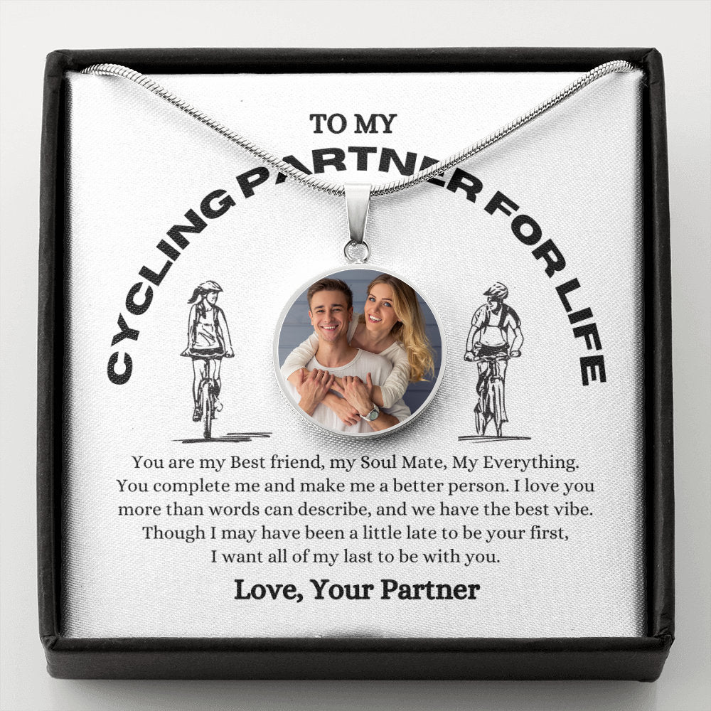 A custom photo pendant necklace, featuring a smiling couple, is presented on a card reading "To My Cycling Partner For Life." This personalized keepsake makes the perfect gift for your wife and soulmate.