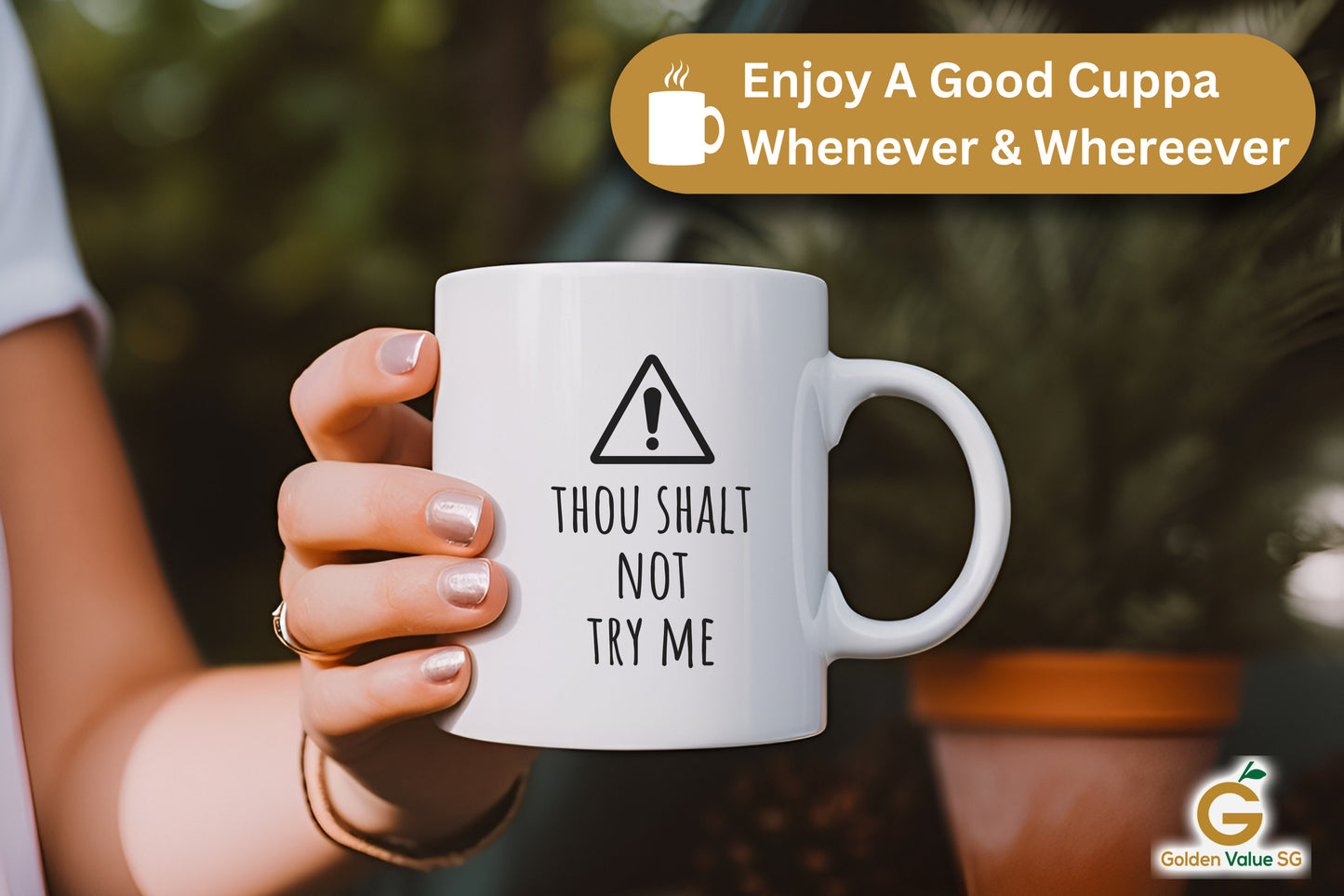 Someone holds the "Thou Shalt Not Try Me" coffee mug among plants. A banner says, "Enjoy a Good Cuppa Whenever & Wherever." It’s an ideal gift for moms who love humor in their morning routine.