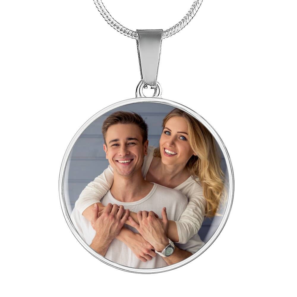 The Custom Photo Pendant Necklace with Message Card, "To My Cycling Partner For Life," showcases a smiling couple, the man in front and the woman embracing him. They wear light-colored clothing. This personalized keepsake is a perfect cyclist gift for your wife or soulmate, capturing cherished moments.