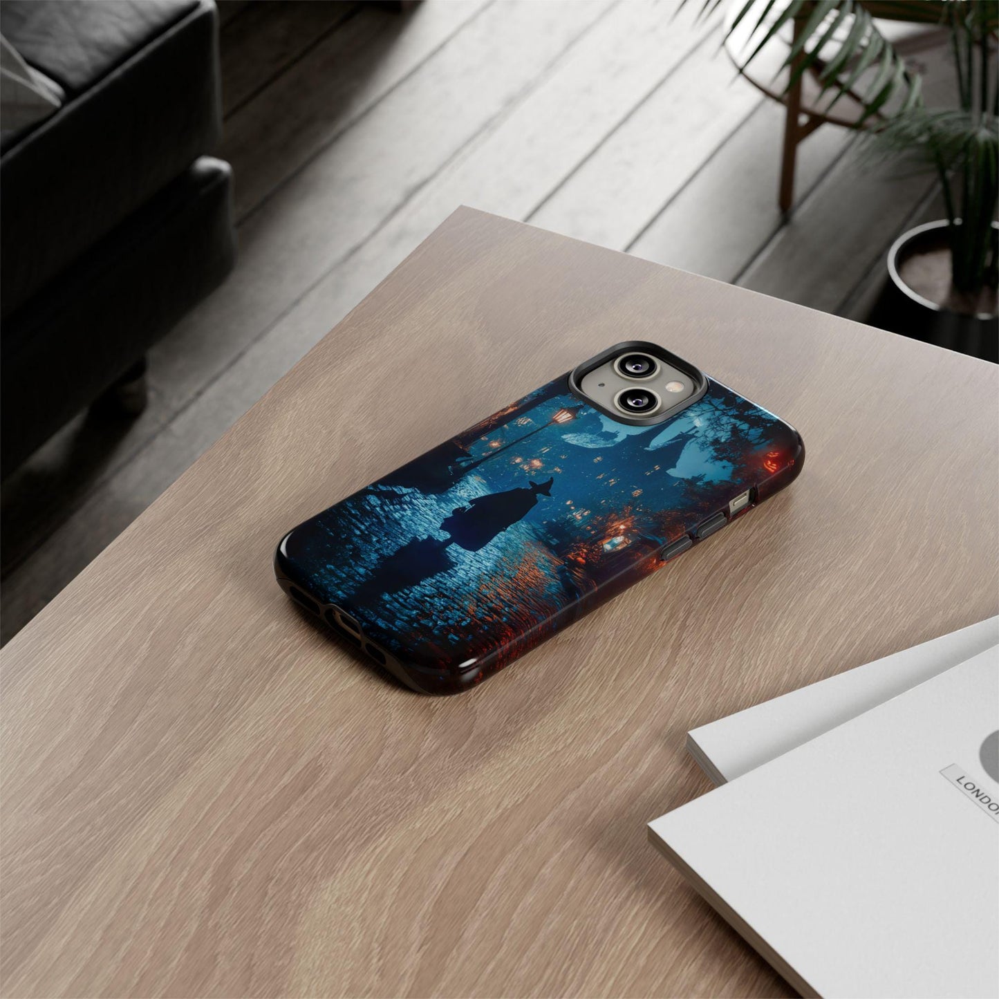 The Witch Walking In Town Halloween Phone Case, with its dark academia and gothic witchy design, is styled as a unique gift, prominently featuring night scene artwork on an iPhone 15. It's placed on a wooden table next to a stack of papers.