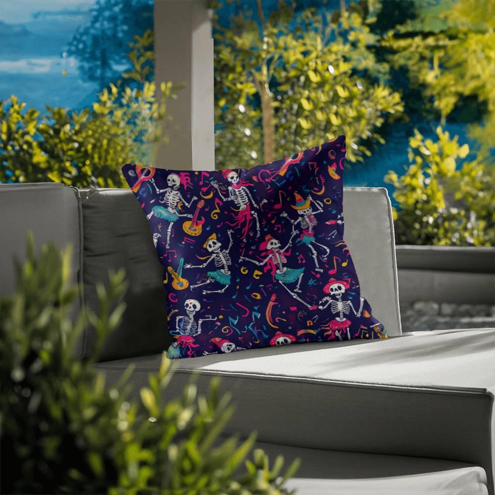 A Dancing Skeleton Pillow from the Mystical Home Decor collection, perfect for Halloween and featuring a spooky skeleton design, rests on the outdoor sofa, surrounded by lush greenery.