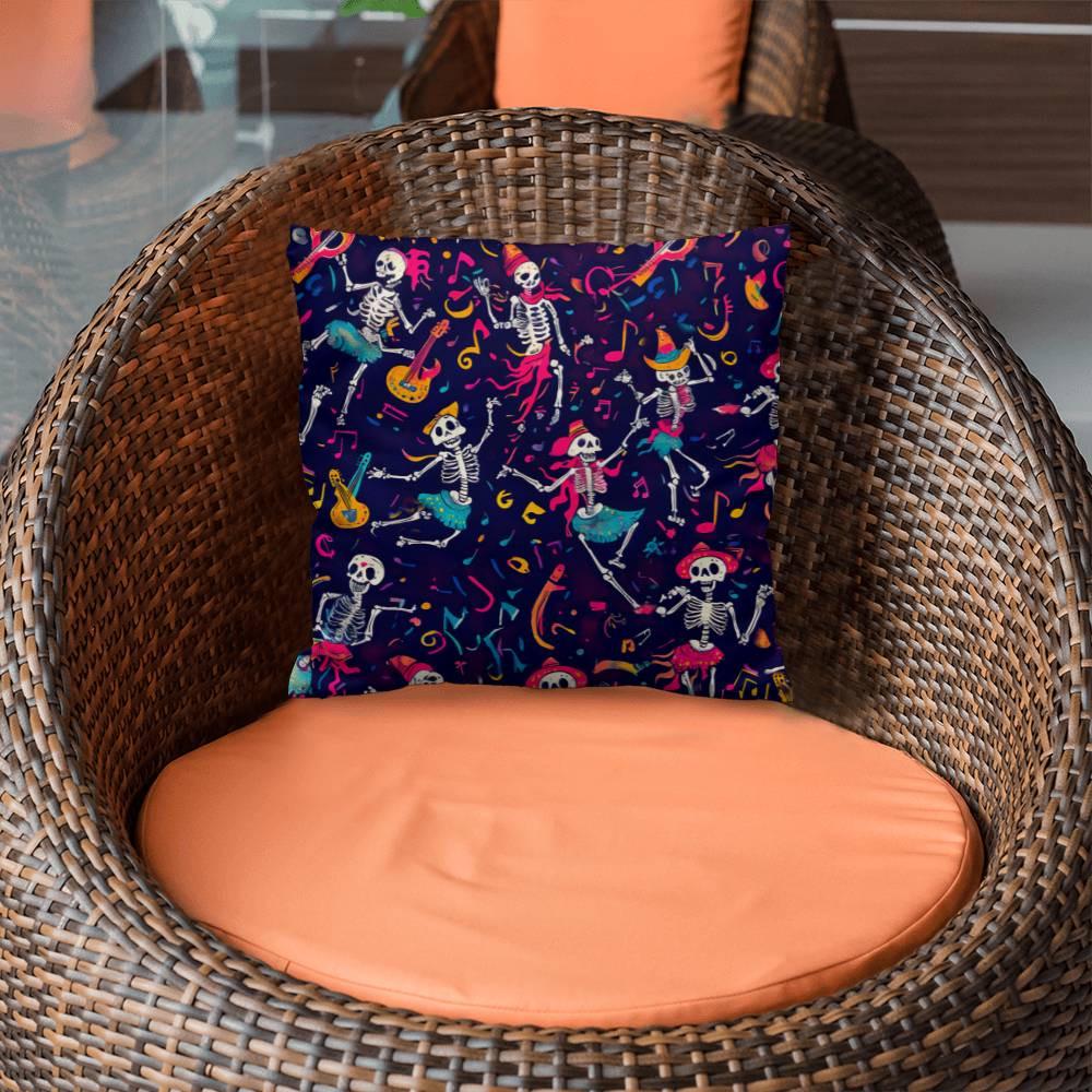 A wicker chair with an orange cushion is adorned with the Dancing Skeleton Pillow, a spooky decorative pillow that showcases a lively pattern of skeletons dancing with guitars, hats, and musical notes on a dark background—ideal for infusing some Halloween charm.